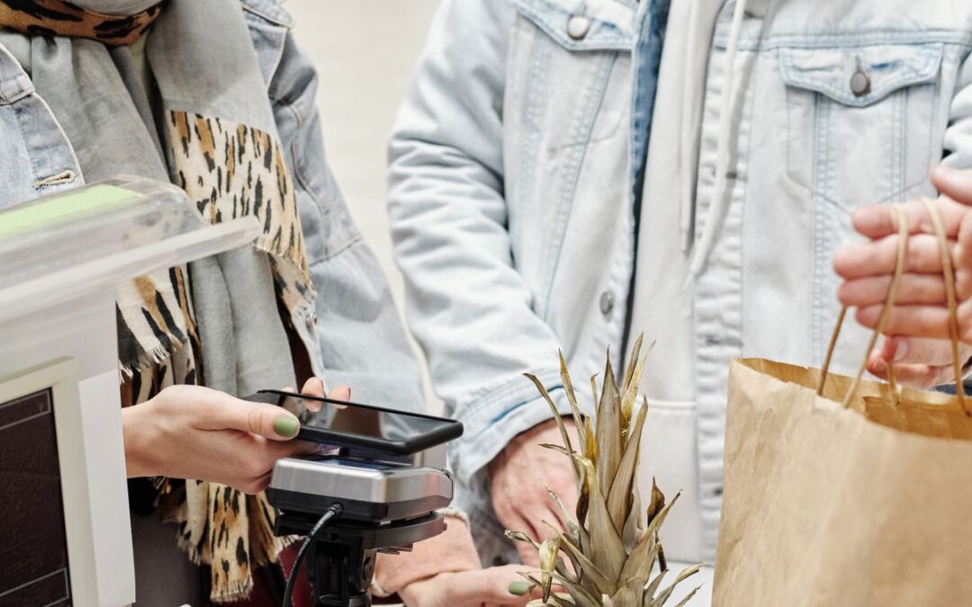 Klant rekent contactloos af met smartphone bij de kassa